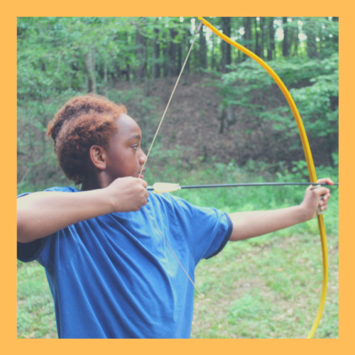 A camper learns archery for the first time.